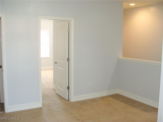 unfurnished room with light carpet