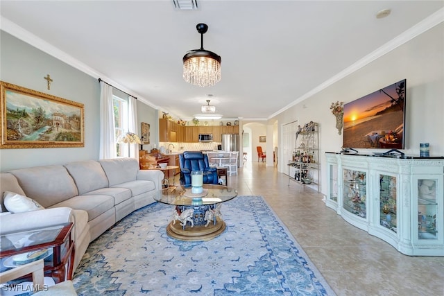 tiled living room featuring an inviting chandelier and ornamental molding