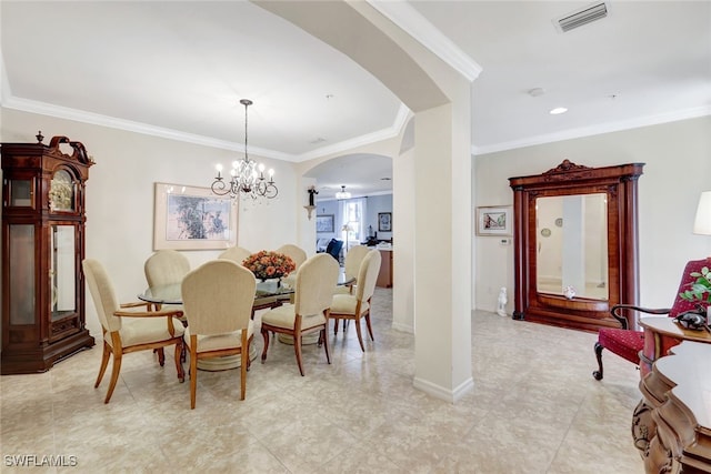 dining area with ornamental molding and a chandelier