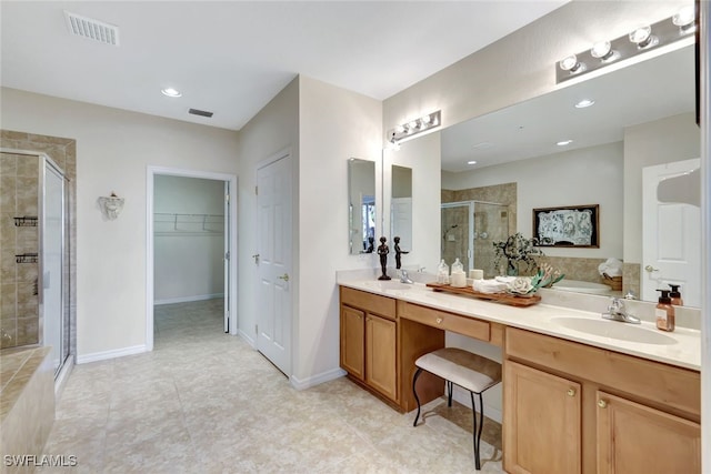 bathroom with vanity and a shower with shower door