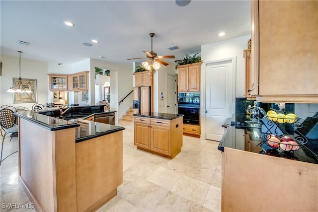 kitchen with hanging light fixtures, a center island, decorative backsplash, stainless steel dishwasher, and kitchen peninsula