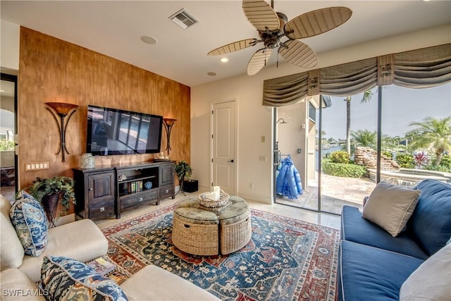 living room featuring tile patterned floors and ceiling fan