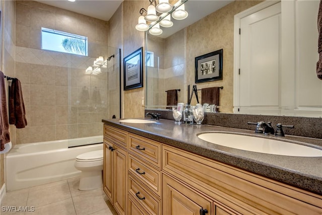 full bathroom featuring vanity, tiled shower / bath, tile patterned floors, and toilet