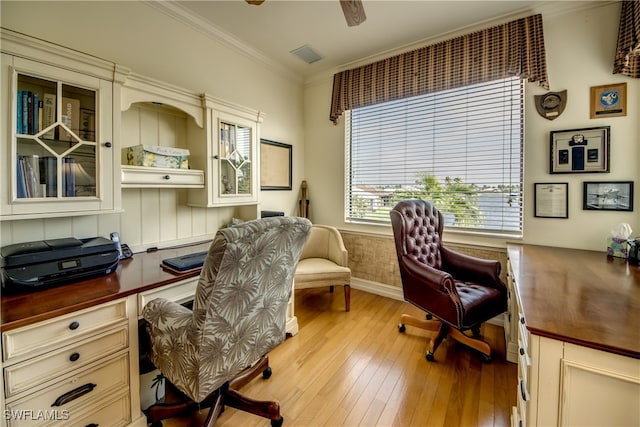 office space with crown molding, ceiling fan, and light hardwood / wood-style floors