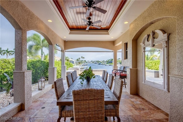 view of patio / terrace with a water view and ceiling fan