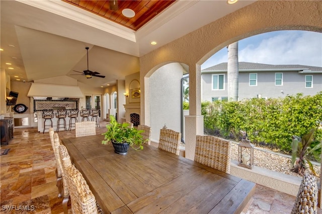 view of patio featuring a bar and ceiling fan