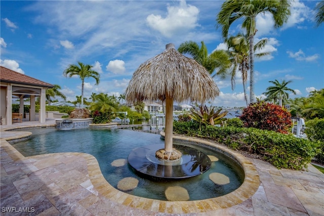 view of swimming pool with a patio and pool water feature