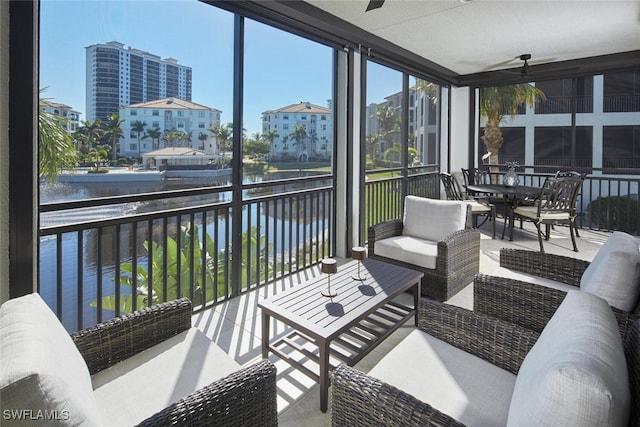 sunroom / solarium featuring a water view