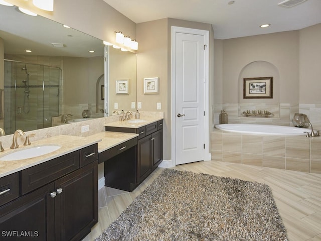 bathroom with vanity and separate shower and tub