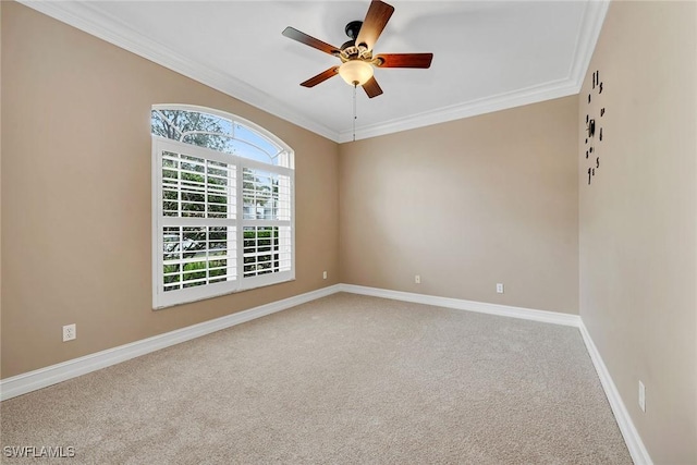 carpeted empty room featuring ornamental molding and ceiling fan