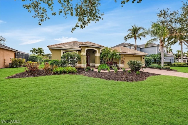 mediterranean / spanish home with a front yard