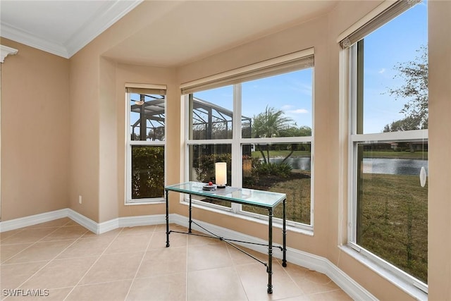 sunroom featuring a water view