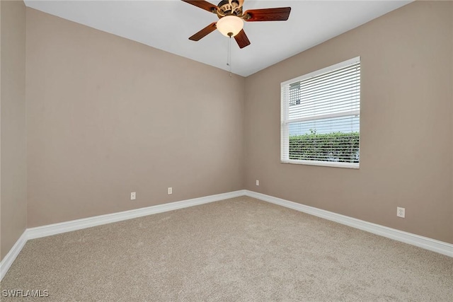 carpeted empty room featuring ceiling fan