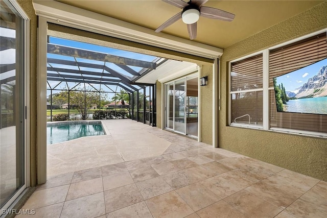 view of pool featuring a patio, a lanai, and ceiling fan