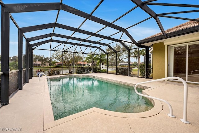 view of swimming pool with a patio area and glass enclosure