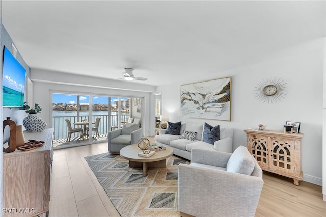 living room with light wood-style floors and ceiling fan