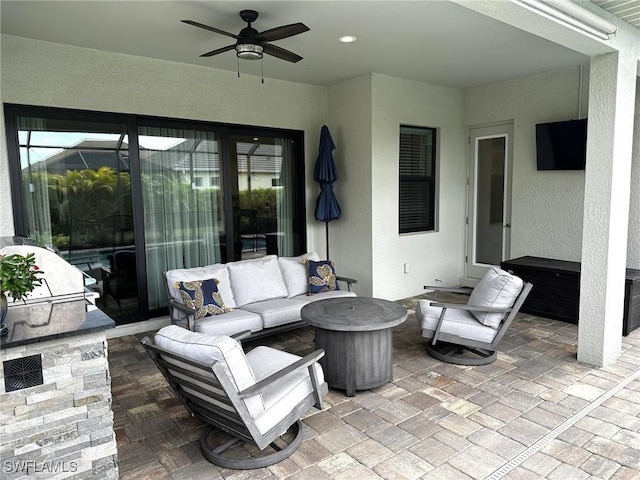 view of patio / terrace with outdoor lounge area, ceiling fan, and an outdoor kitchen