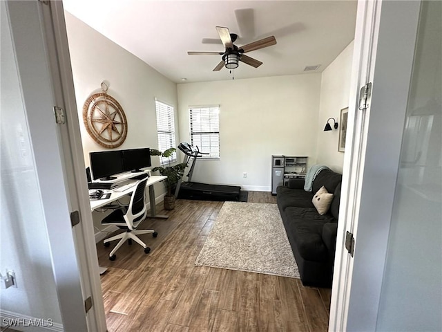 office area featuring baseboards, ceiling fan, visible vents, and wood finished floors