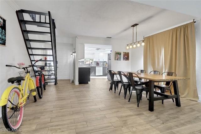 dining room featuring light hardwood / wood-style flooring and ceiling fan