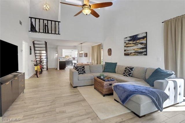 living room with ceiling fan and light hardwood / wood-style flooring