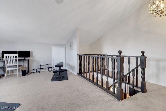 living area with carpet floors, a chandelier, and vaulted ceiling