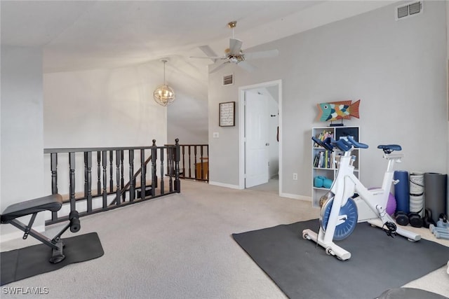 exercise area featuring vaulted ceiling, carpet, and a notable chandelier