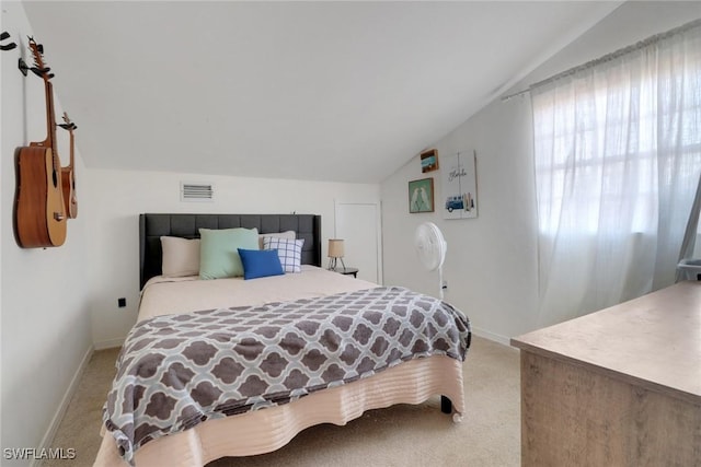 bedroom featuring vaulted ceiling and carpet flooring