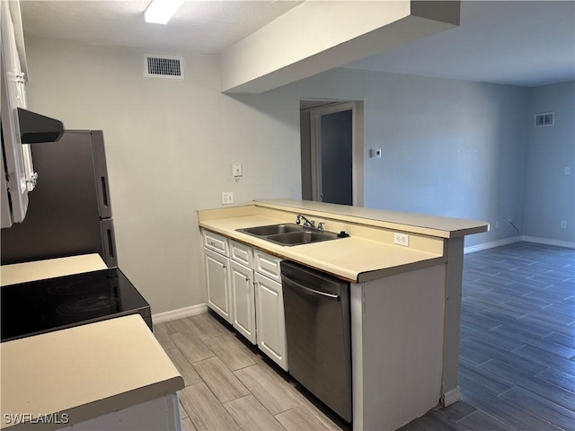 kitchen with dishwasher, sink, stainless steel fridge, and kitchen peninsula