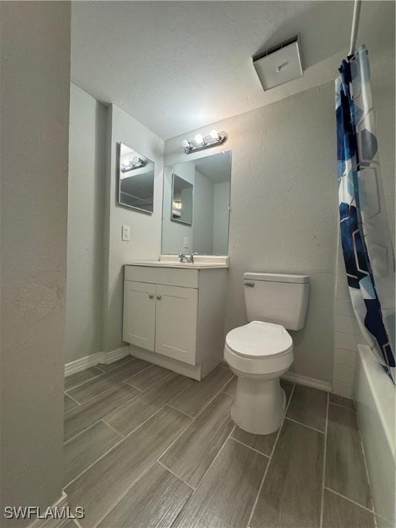 full bathroom with shower / bath combo, vanity, and toilet