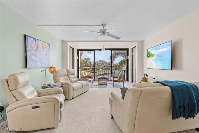 carpeted living room with expansive windows and ceiling fan