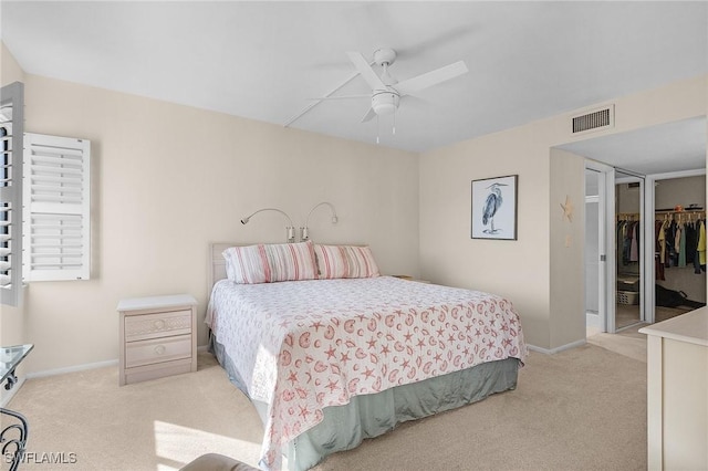 carpeted bedroom featuring ceiling fan, a spacious closet, and a closet