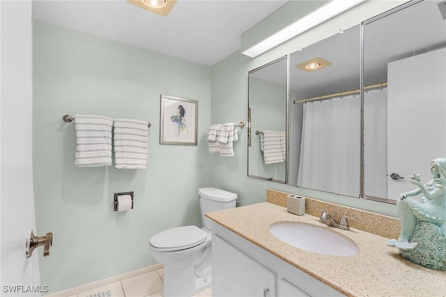 bathroom with vanity, toilet, and tile patterned flooring