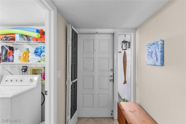 laundry room with washer / dryer and light tile patterned floors