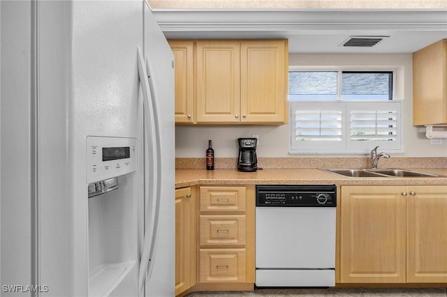 kitchen featuring white appliances, sink, and light brown cabinets