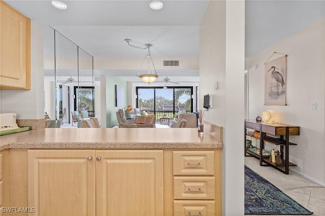 kitchen with ceiling fan, pendant lighting, light brown cabinetry, and kitchen peninsula