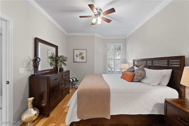 bedroom featuring crown molding, ceiling fan, and light wood-type flooring