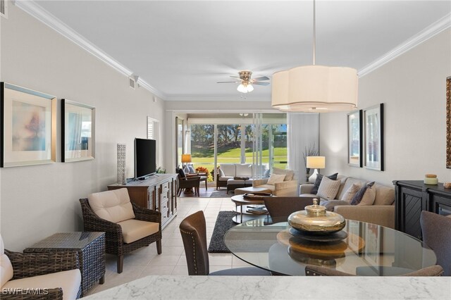 living room featuring ceiling fan, ornamental molding, and light tile patterned floors