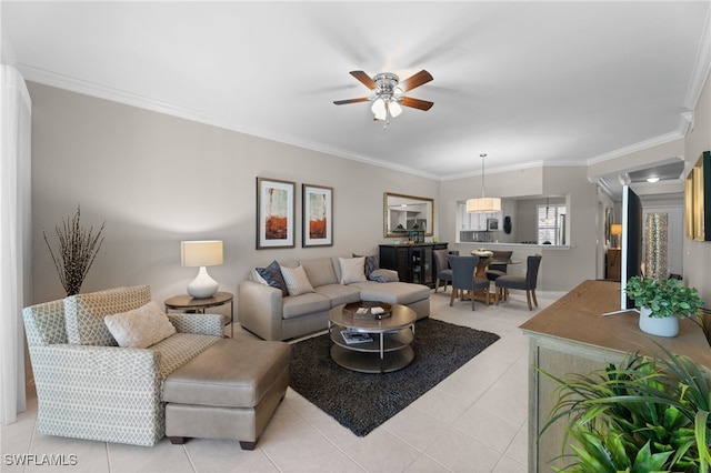 living room with ornamental molding, light tile patterned floors, and ceiling fan