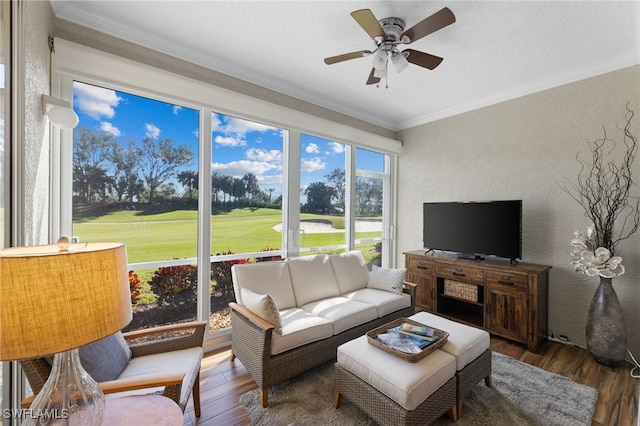 sunroom / solarium featuring ceiling fan