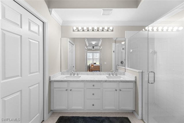 bathroom with tile patterned floors, ornamental molding, a shower with door, and vanity