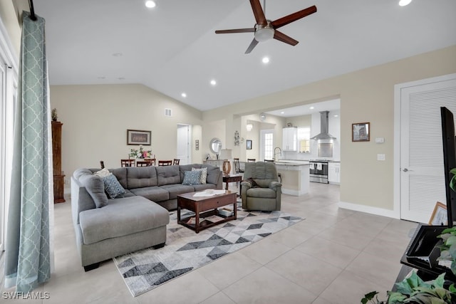 living room with lofted ceiling, light tile patterned floors, sink, and ceiling fan