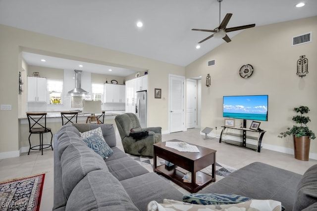 tiled living room featuring high vaulted ceiling and ceiling fan