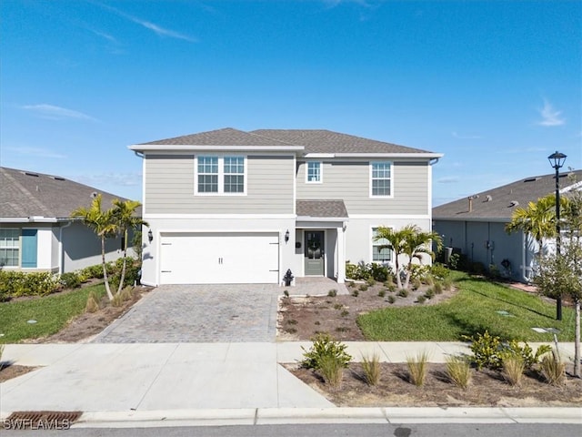 42443 Cascade Dr, Punta Gorda, FL 33982 - traditional-style home with an attached garage, roof with shingles, and decorative driveway