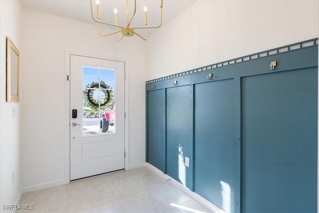 doorway to outside featuring light tile patterned floors and a notable chandelier