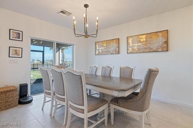 dining space with a notable chandelier, visible vents, baseboards, and light tile patterned flooring