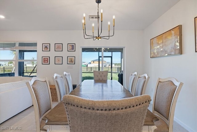 dining space with an inviting chandelier, light tile patterned floors, baseboards, and visible vents