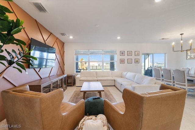 living area with recessed lighting, visible vents, and a notable chandelier