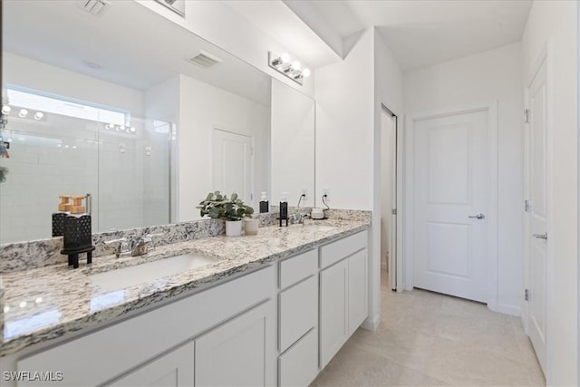 42443 Cascade Dr, Punta Gorda, FL 33982 - bathroom featuring double vanity, a sink, visible vents, and a stall shower