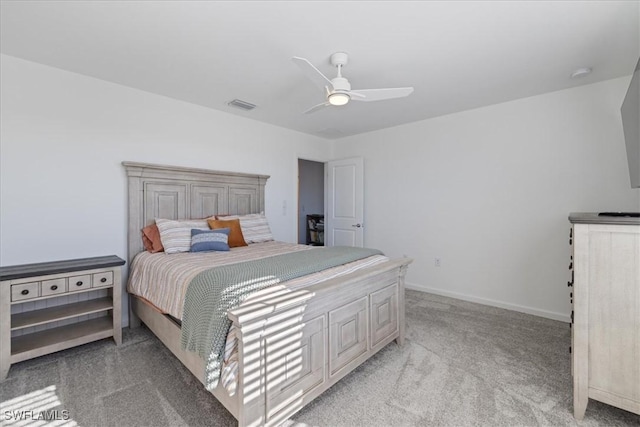 bedroom with ceiling fan, light colored carpet, visible vents, and baseboards