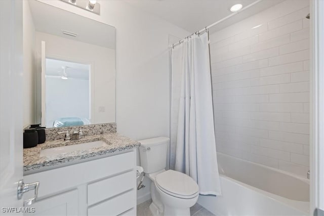 full bathroom with shower / tub combo with curtain, vanity, and toilet